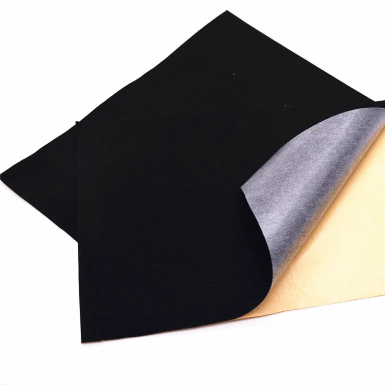 Black plush gauze fabric with exposed adhesive backing substrate