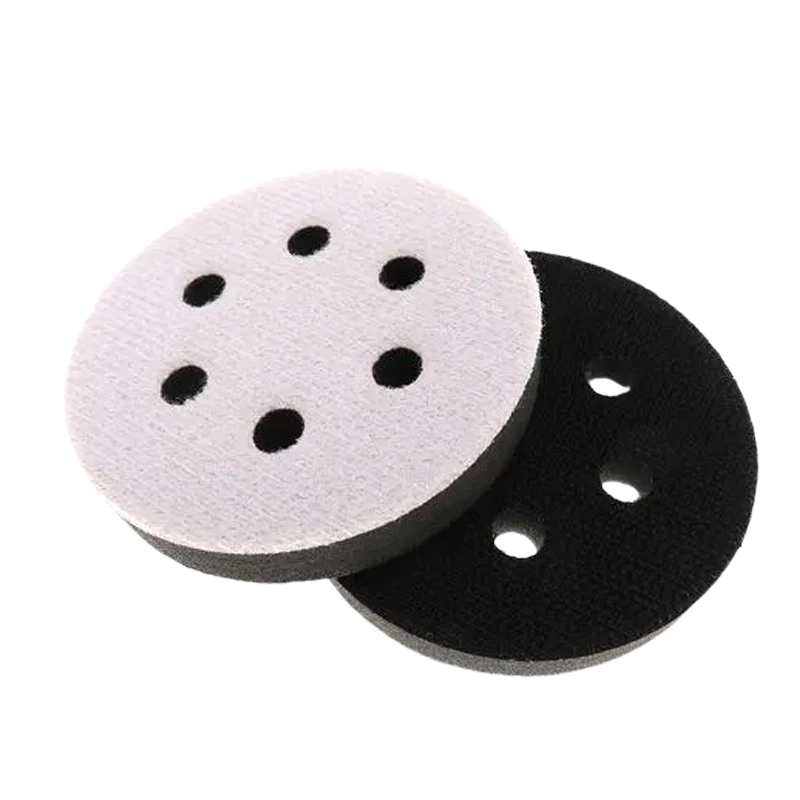 Grinding Pad, off‑white and black circular grinding pad