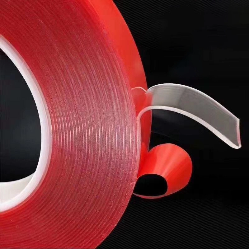 Transparent high‑viscosity double‑sided tape roll equipped with red release film