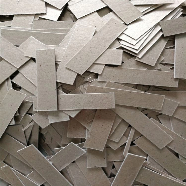 Mica die‑cut leftover off‑cuts, different strip‑shaped fragments