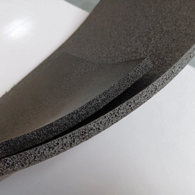 Bent black XPE foam sheet revealing layered composite interface